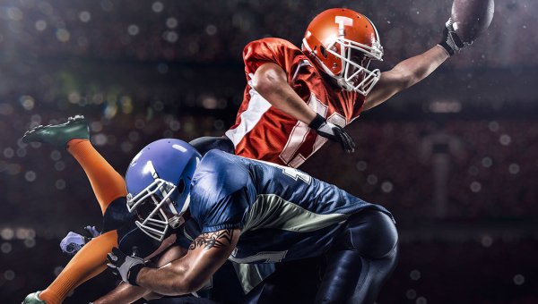 Football player scoring touchdown. 
