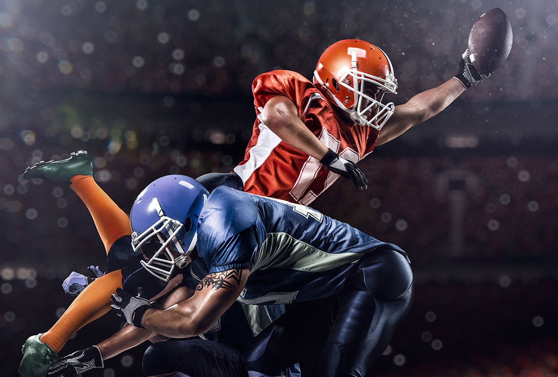 Football player scoring touchdown. 